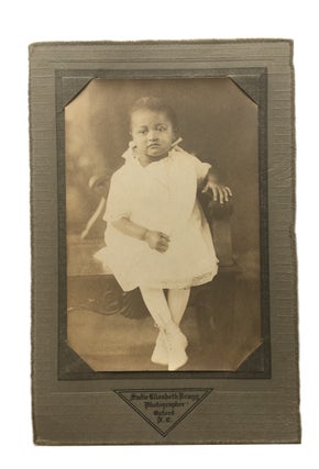 Item #85960 Unsmiling young African American Girl. Photograph