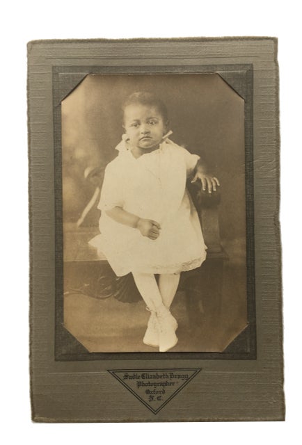 Item #85960 Unsmiling young African American Girl. Photograph.