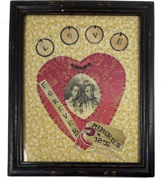 Item #91599 Framed Fabric Handwork with Image of Two Unidentified African American Women stitched in the center of a red fabric heart which is stitched in the center of other patterned material with appropriately placed words adding sentiment.