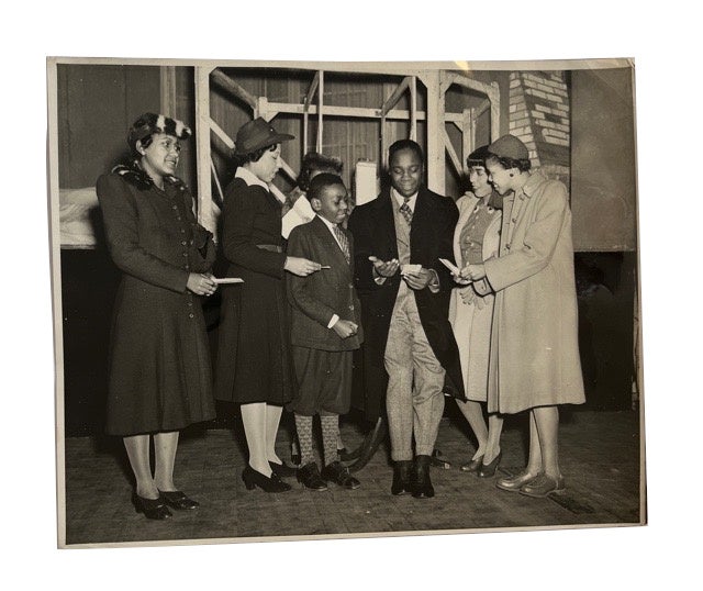 Item #92428 Photo of Canada Lee surrounded by Five Unidentified Women and a Boy. Photograph, Canada Lee.